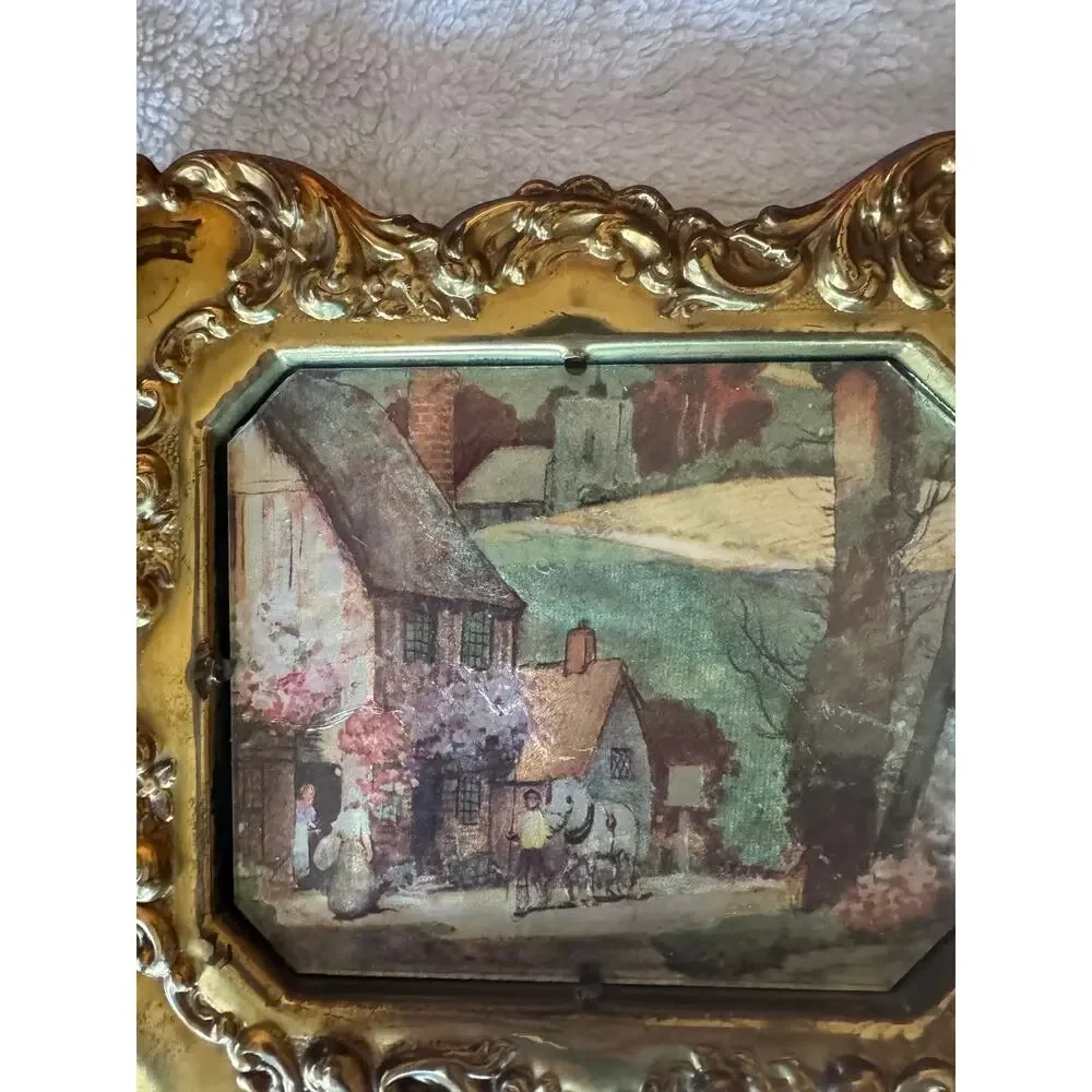 Vintage embossed brass frame with a foil print of an English countryside.